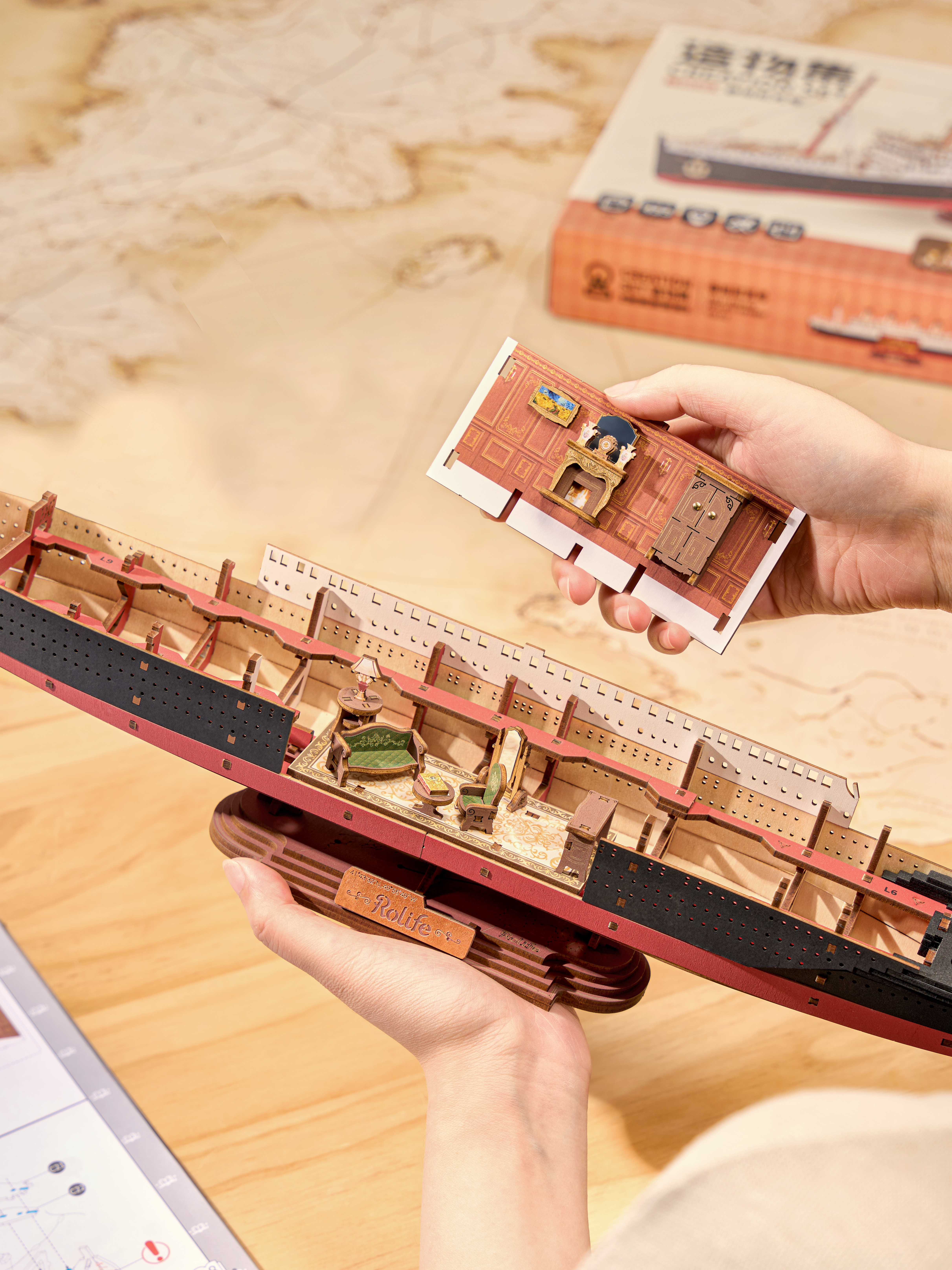 Hands assembling the Rolife Eternal Atlantic Voyager DIY wooden 3D puzzle ship model kit with laser-cut pieces