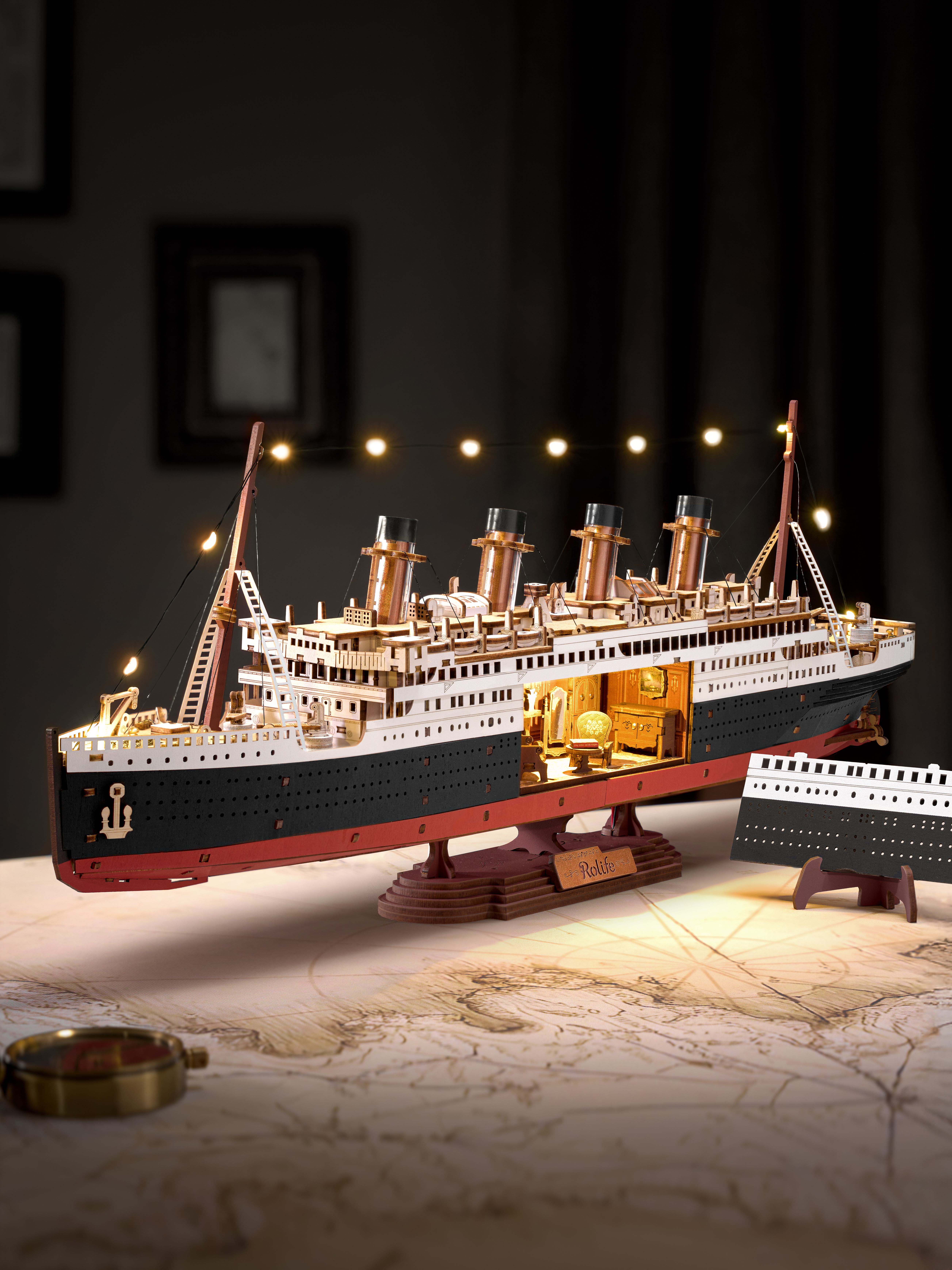 Hands assembling the Rolife Eternal Atlantic Voyager DIY wooden 3D puzzle ship model kit with laser-cut pieces